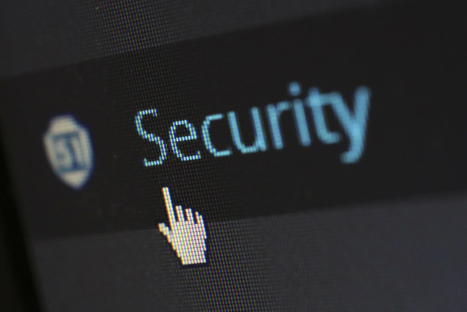 Macro close-up of a screen showing the word Security with a hand cursor