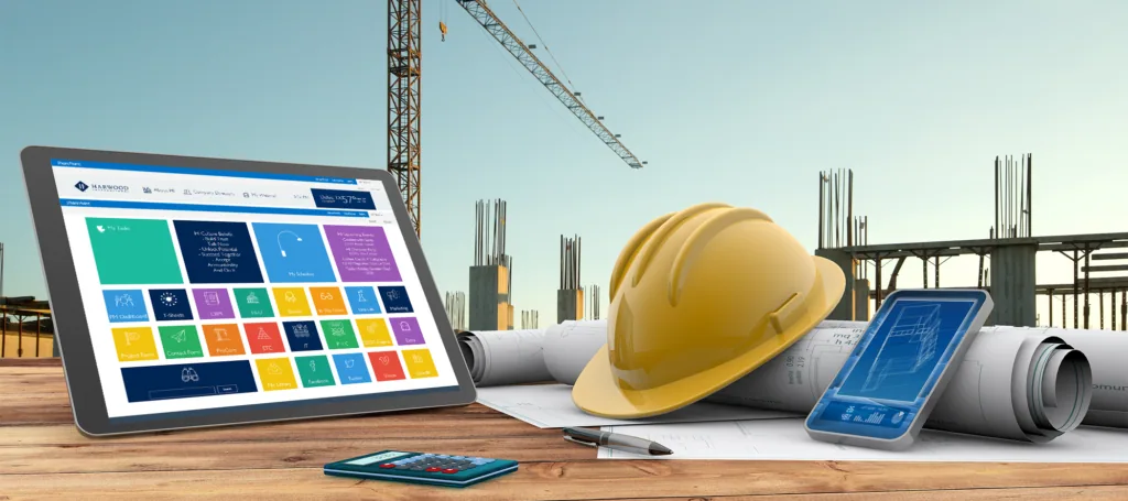 Tablet showing color swatches beside a hard hat and blueprints on a construction site.
